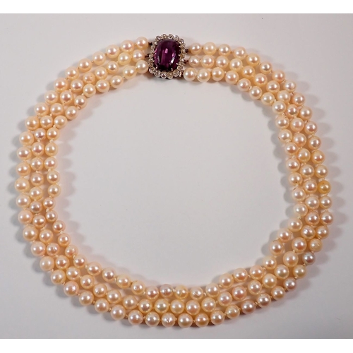 A three string pearl necklace with diamond and amethyst set clasp ...