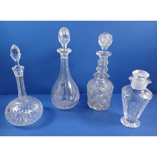 124 - Three various cut glass decanters and a cut glass carafe with double lip and lid