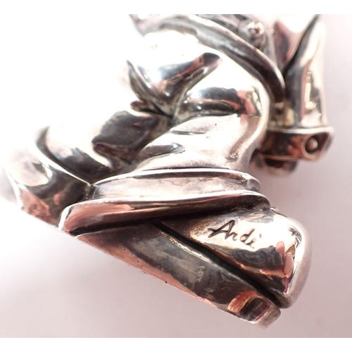 133 - A pair of silver plated on copper clown figures marked Ardi, 7cm tall