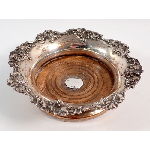 145 - A Victorian Sheffield plated bottle coaster with vine decoration and silver insert to wooden base, 1... 