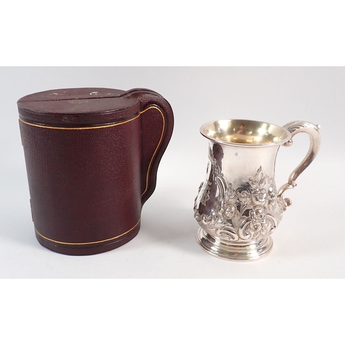 152 - A Victorian silver bombe form christening mug with embossed decoration, in fitted case, by William E... 