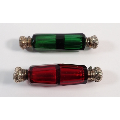 154 - A Victorian red glass double ended scent bottle and a green glass one, both with silver plated lids,... 