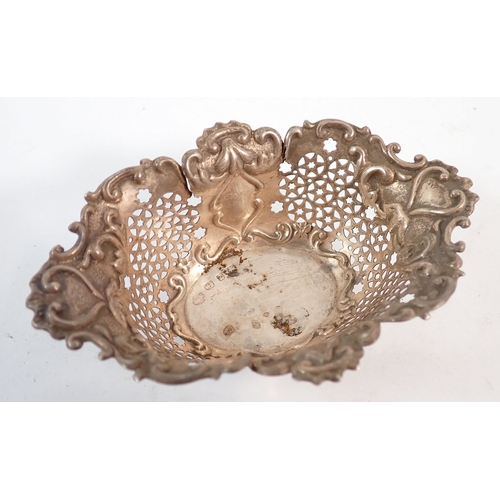 172 - A silver pierced bon bon basket - a/f, a silver thimble, silver topped toiletry bottle and napkin ri... 