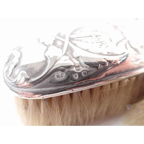 175 - A pair of Victorian silver brushes embossed angel heads