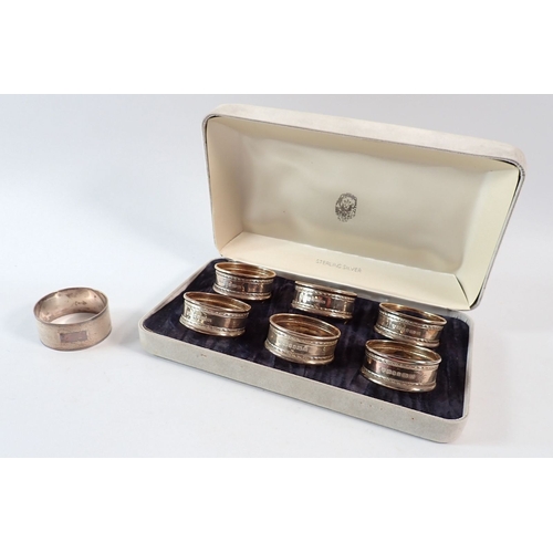 177 - A set of six silver napkin rings, Ari D Norman, London 1994 - boxed and one other, 68g