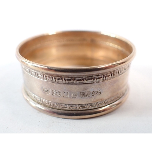 177 - A set of six silver napkin rings, Ari D Norman, London 1994 - boxed and one other, 68g