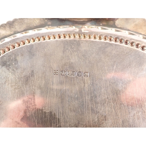 184 - A Victorian silver salver with engraved scrolling roundel decoration and foliate beaded border, cent... 
