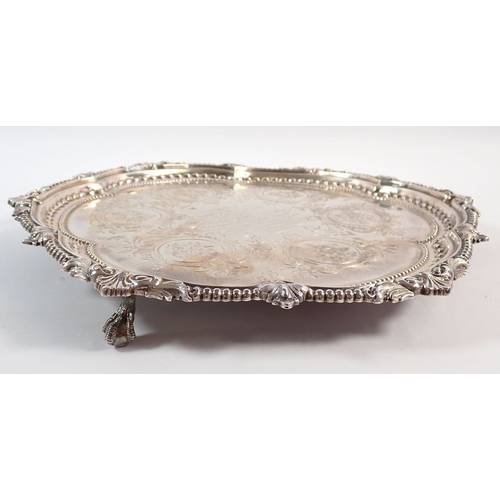 184 - A Victorian silver salver with engraved scrolling roundel decoration and foliate beaded border, cent... 