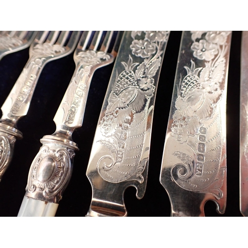 187 - A Victorian silver and mother of pearl set of twelve fruit knives and forks with engraved decoration... 