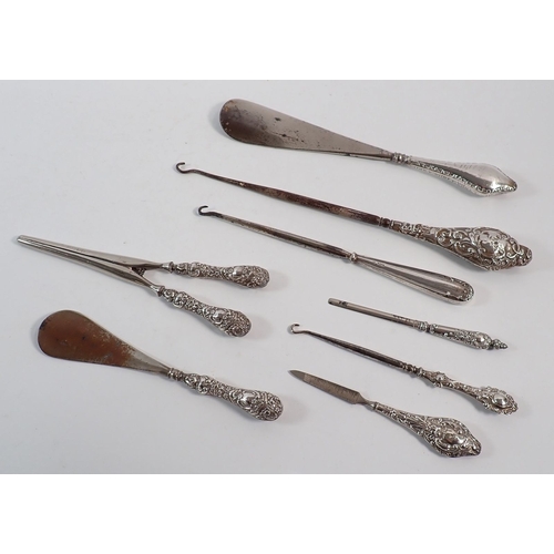190 - A group of silver handled shoe horns, button hooks etc.