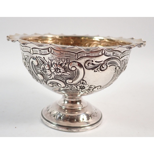 194 - A silver circular pedestal dish with gilt interior and embossed scrollwork and floral decoration, Lo... 