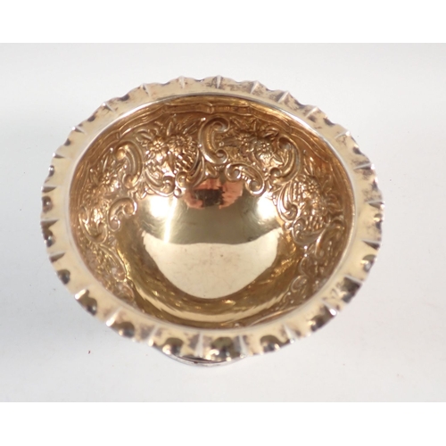 194 - A silver circular pedestal dish with gilt interior and embossed scrollwork and floral decoration, Lo... 