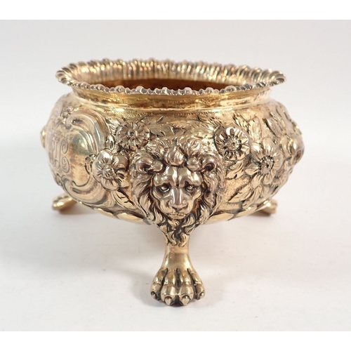 199 - A fine quality Regency silver gilt sugar bowl with floral repousse decoration, all on triple lion pa... 