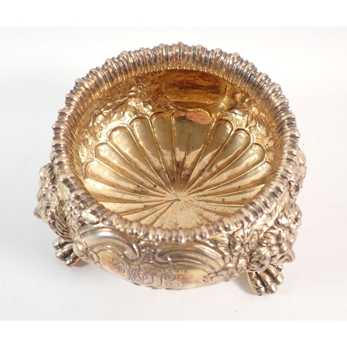 199 - A fine quality Regency silver gilt sugar bowl with floral repousse decoration, all on triple lion pa... 
