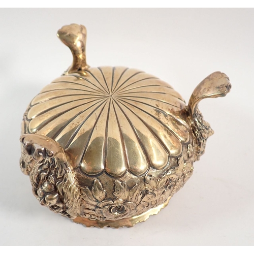 199 - A fine quality Regency silver gilt sugar bowl with floral repousse decoration, all on triple lion pa... 