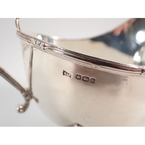 209 - A silver sauce boat with three foliate pad feet, Walker & Hall, Sheffield 1926, 148g