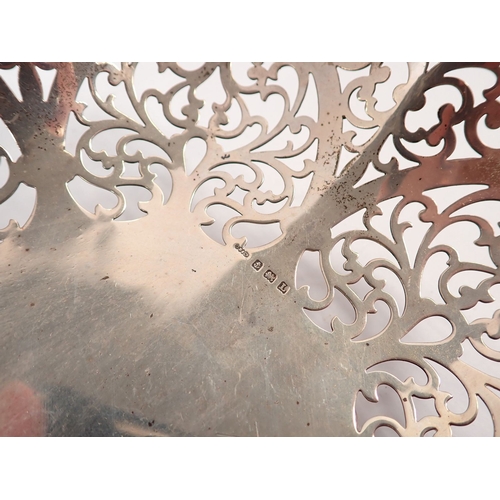 216 - A silver basket with pierced scrollwork decoration on ball feet by G Bryan & Co, Birmingham 1935, 22... 