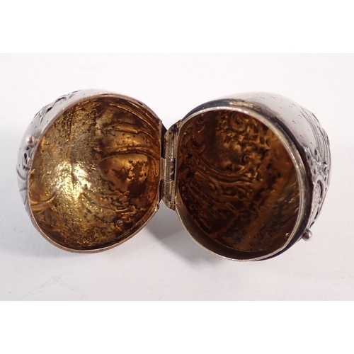 220 - A antique egg form novelty nutmeg grater (lacking grater) with embossed bullrush and scrollwork deco... 