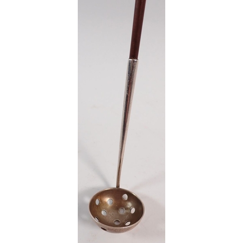 222 - A silver strainer spoon with wooden handle, 30cm long