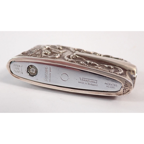 228 - A sterling silver cased Ronson lighter with Eastern dancer decoration, 6.5cm long