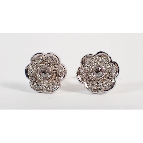 236 - A pair of 18 carat white gold and diamond floral cluster earrings, 4.6g
