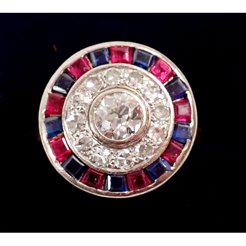 242 - An 18 carat gold, sapphire, ruby and diamond target ring, the central diamond (approx 5mm) within bo... 