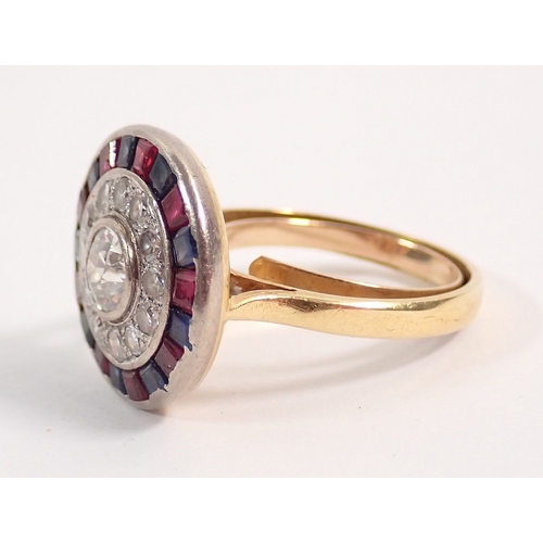 242 - An 18 carat gold, sapphire, ruby and diamond target ring, the central diamond (approx 5mm) within bo... 