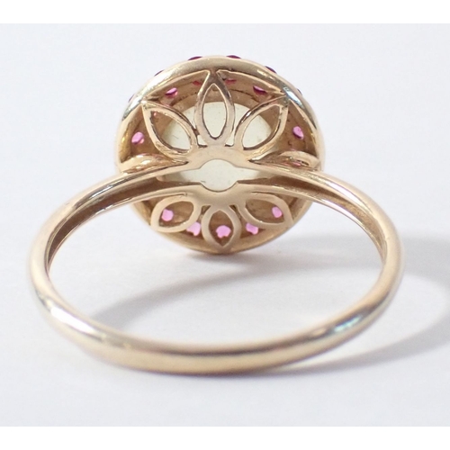 257 - An 18ct gold ring set cabochon lemon quartz with pink sapphire halo by Rosa De La Cruz, size M 2.6g