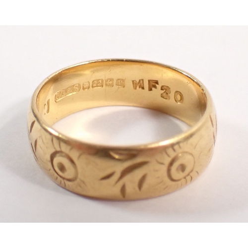 265 - A 22 carat gold wedding band with engraved decoration, 6mm wide, size M, 6.4g