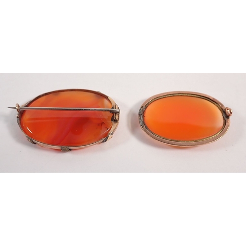 284 - Two orange agate brooches with 9ct gold mounts, one pin a/f, largest 4.2 x 3cm, unmarked but tested