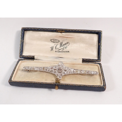 298 - An Art Deco 18 carat white gold and platinum diamond bar brooch (central diamond 4.9mm) 8cm wide - i... 