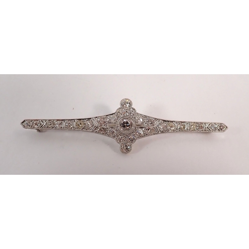 298 - An Art Deco 18 carat white gold and platinum diamond bar brooch (central diamond 4.9mm) 8cm wide - i... 