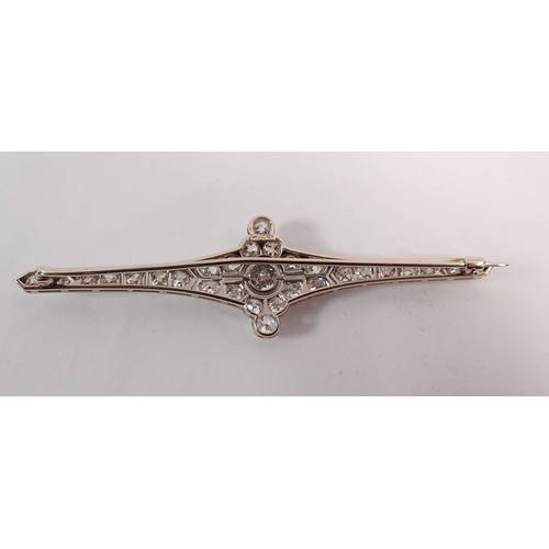 298 - An Art Deco 18 carat white gold and platinum diamond bar brooch (central diamond 4.9mm) 8cm wide - i... 