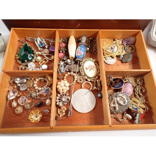 405 - A box of various costume jewellery including brooches etc.
