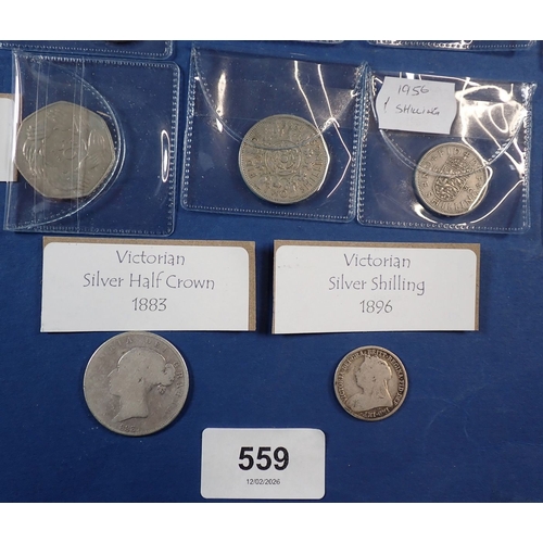 559 - A Victoria silver half crown and shilling plus various British coins including crowns, fifty pences,... 