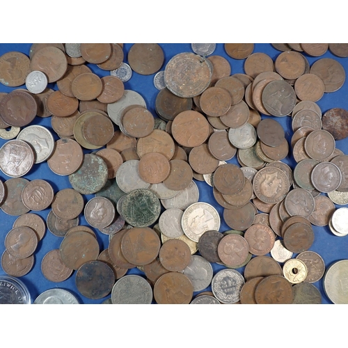 566 - A collection of mostly British coins including George III farthing, commemorative crowns etc plus a ... 