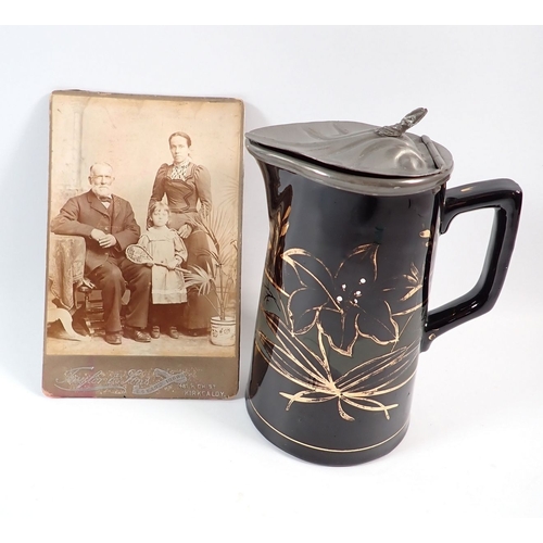 63 - A Victorian Jackfield pottery style water jug with a pewter lid, 17cm tall accompanying photo of ori... 