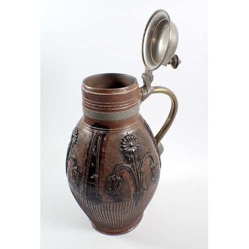 18 - An 18th century German stoneware Muskau beer stein with applied flower motif, pewter lid and brass r... 