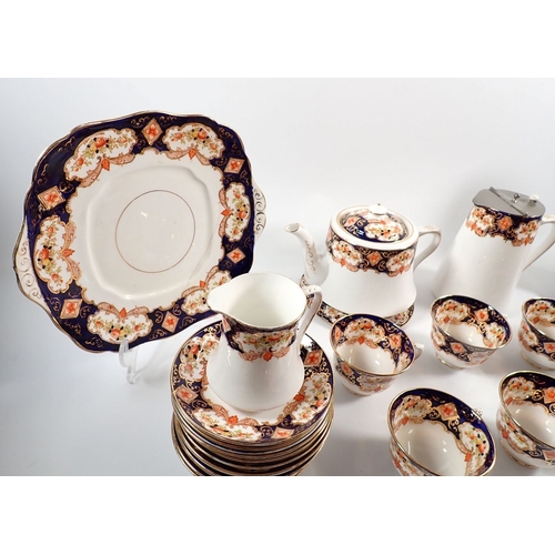 24 - A Royal Albert 1920's tea set comprising teapot with stand, coffee pot, milk jug, sugar, twelve cups... 