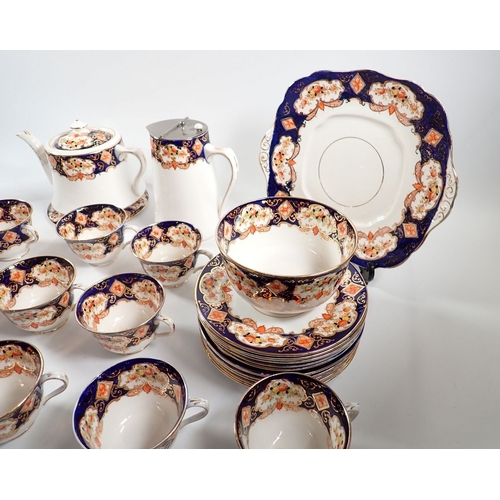 24 - A Royal Albert 1920's tea set comprising teapot with stand, coffee pot, milk jug, sugar, twelve cups... 