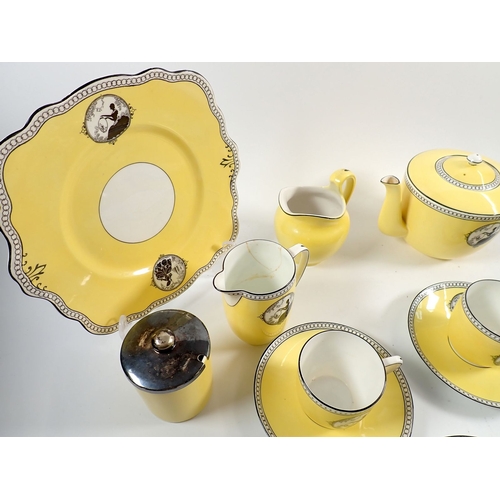 25 - A Foley yellow silhouette part tea set No 303 comprising teapot, five cups and saucers, six tea plat... 