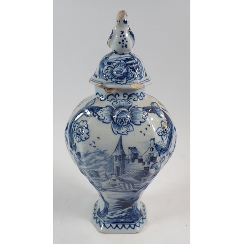 127 - A Delft vase and cover painted town scenes with bird finial, 25cm - some damage