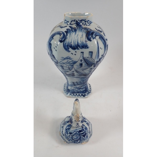 127 - A Delft vase and cover painted town scenes with bird finial, 25cm - some damage