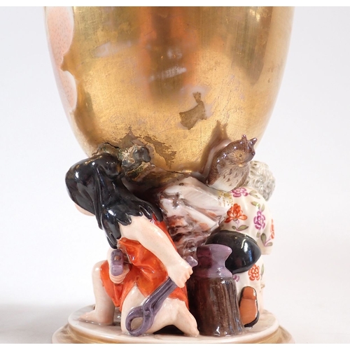 132 - A pair of 19th century Berlin gilt porcelain goblets painted reserves of cherubs in the clouds on fi... 