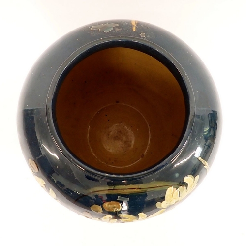 14 - A large Majolica pottery vase painted daisies on a blue ground, 50cm high