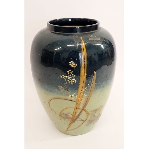 14 - A large Majolica pottery vase painted daisies on a blue ground, 50cm high