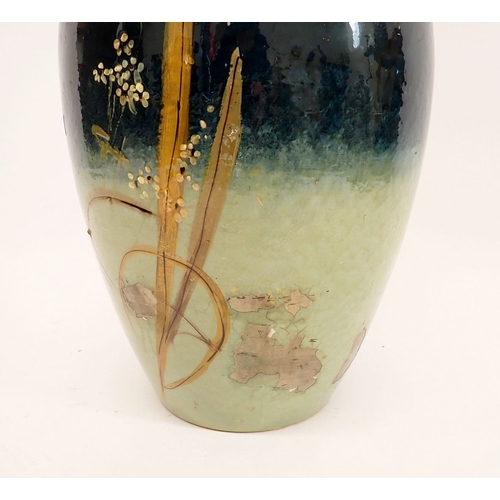 14 - A large Majolica pottery vase painted daisies on a blue ground, 50cm high