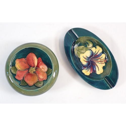 140 - A Moorcroft ashtray painted yellow hibiscus with paper Queen Mary label, 15.5cm wide plus a Moorcrof... 