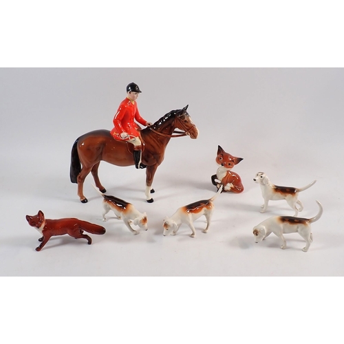 148 - A Beswick huntsman on horse, four hounds and a fox plus a character fox, 9cm tall