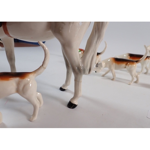 149 - A Beswick set of seven hounds and a fox plus a huntswoman (leg a/f) 21.5cm tall, and another hound a... 